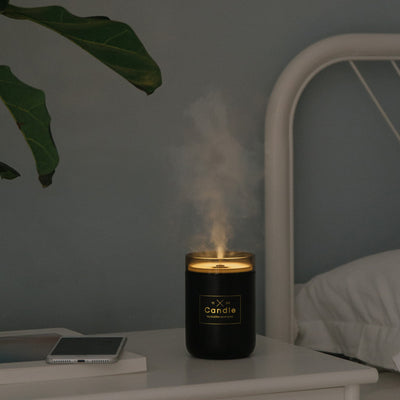 Light pink mini USB humidifier diffuser, shaped like a candle, with a clear top and visible mist output. - Image 2