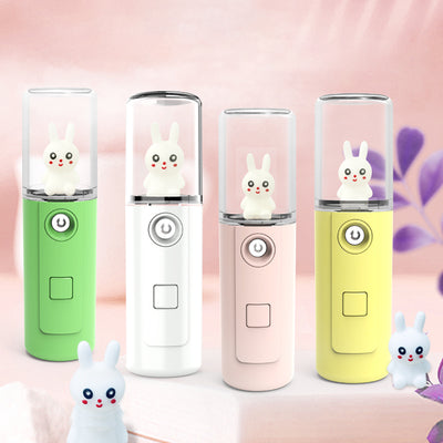 Green portable facial mister with a clear top and a white cartoon rabbit figure inside, featuring a power button. - Image 7