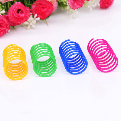 Four colorful plastic spring cat toys in green, blue, orange, and pink, packaged in a clear plastic bag. - Image 3