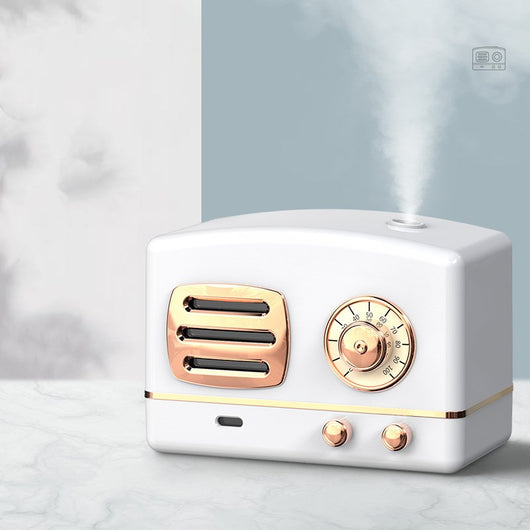 White retro humidifier with rose gold accents, designed like a vintage radio, emitting a fine mist. - Image 6