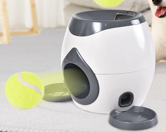 Smart pet feeder and tennis ball reward machine in white and lime green, with two mini tennis balls and a scoop. - Image 7