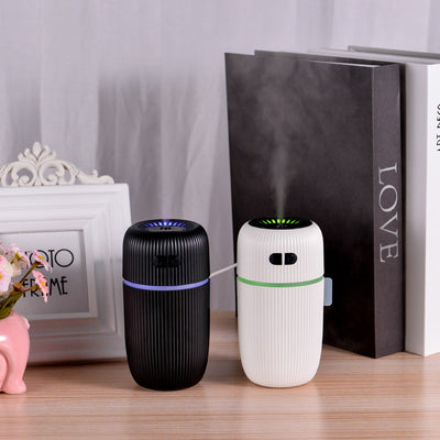 Black ribbed white noise humidifier with control buttons on top, designed to aid sleep and humidify.