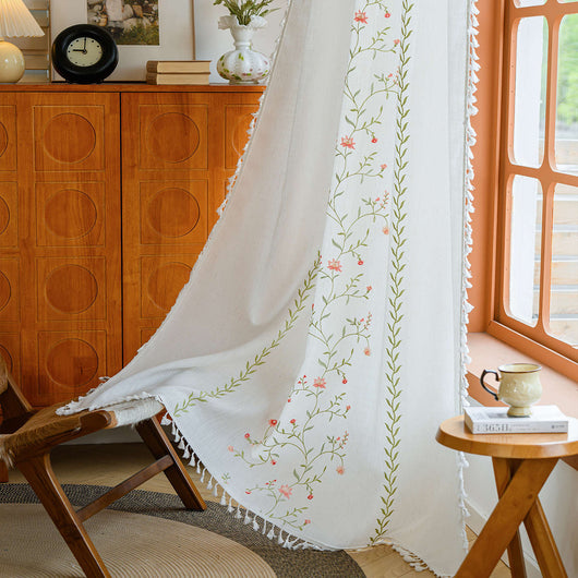 White semi-sheer curtain with brown botanical embroidery and white tassels, draped over a small wooden table. - Image 12