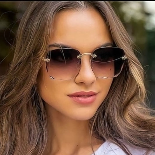 Pink rimless square sunglasses with wavy edges, gold-tone hardware, and clear pink temples on a white background. - Image 2