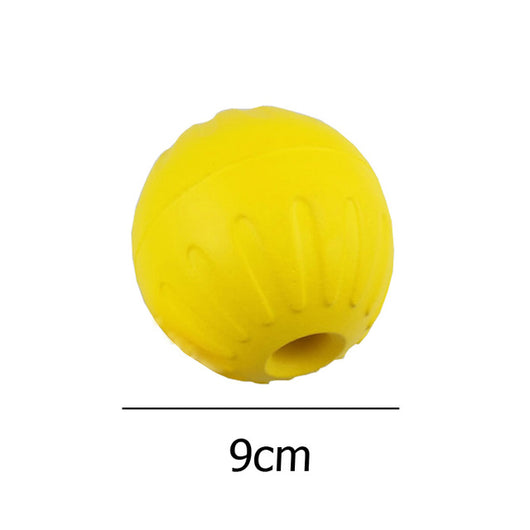 Bright yellow EVA pet ball dog toy with textured grooves and paw print details for interactive play. - Image 10
