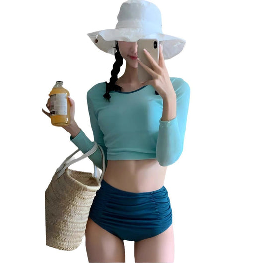 Woman in a pink long-sleeved crop top and black high-waisted ruched swim bottoms, posing in a mirror. - Image 5