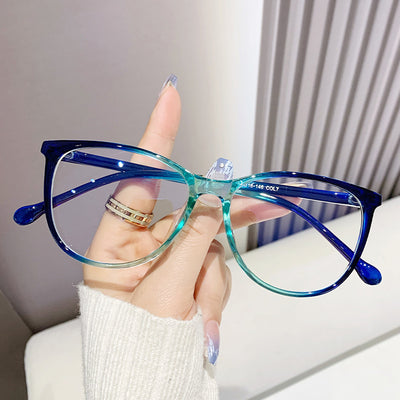 Black full-frame round anti-blue light glasses held by a hand with a gold ring and light blue gradient nails. - Image 3