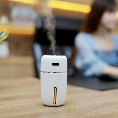 Black portable humidifier with a silver band, a power button, and a water level indicator, suitable for car or home. - Image 4