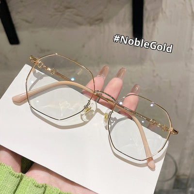 Rose gold frameless polygon anti-blue light glasses with clear lenses, held by a hand with pink nails. - Image 7