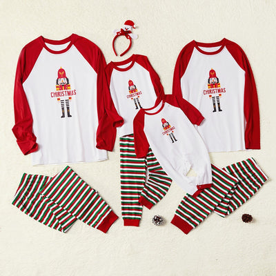 Matching family Christmas pajamas with white raglan tops, red sleeves, and a nutcracker graphic, paired with red, green, and white striped pants. Includes adult - Image 11