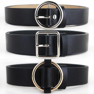 Black faux-leather women's belt with a shiny gold-tone round pin buckle, displayed on a white background.