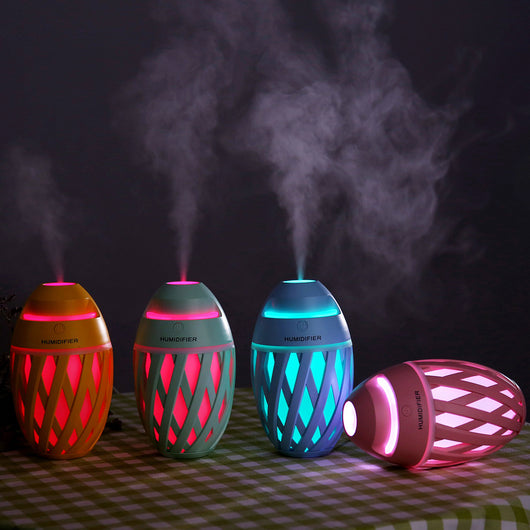 Light green football-shaped humidifier with a decorative lattice pattern and a power button on top. - Image 5