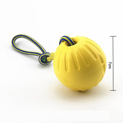 Bright yellow EVA pet ball dog toy with textured grooves and paw print details for interactive play. - Image 12