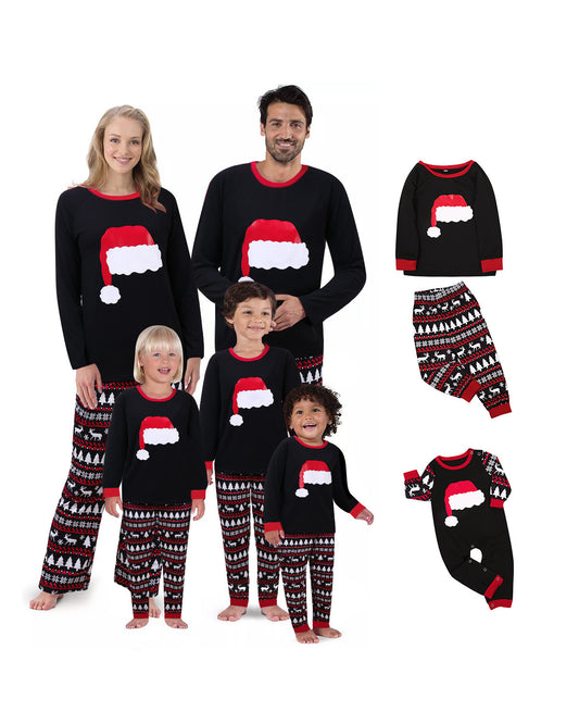 Family of four in black and red matching Christmas pajamas with Santa hat tops and fair isle pants. Also shown: a two-piece set and a baby romper.