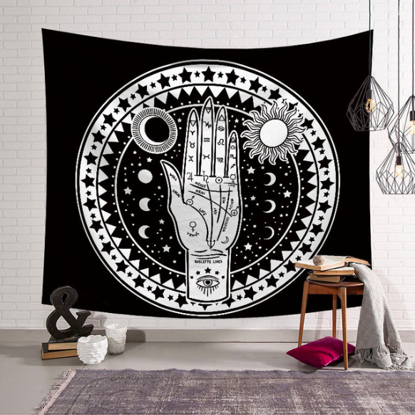 Black and white tapestry featuring a palmistry hand with sun, moon, and stars, perfect for mystical home decor.
