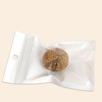 Natural catnip treat ball, spherical and covered in dried brown plant material, for cats to play with. - Image 3