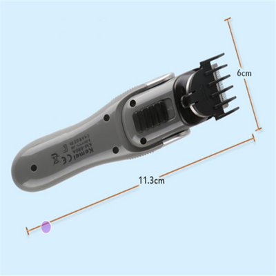 Kemei multi-function hair clipper set with silver and black body, orange buttons, and multiple interchangeable heads on a black charging base. - Image 5