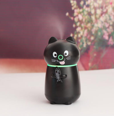 White cartoon cat humidifier with a pink tongue, black eyes, and whiskers, holding a fish skeleton, with a glowing blue light band. - Image 7