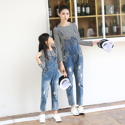 Mother and daughter wearing matching distressed denim overalls over black and white striped long-sleeve shirts. - Image 5