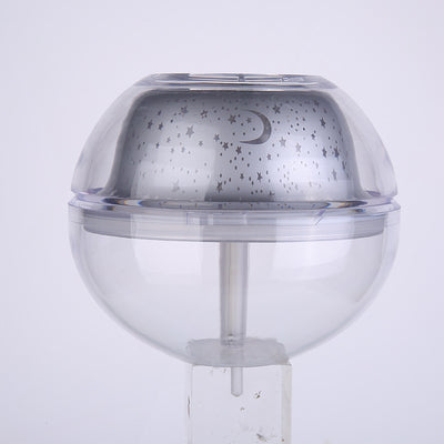 Silver and clear spherical essential oil diffuser with a starry night LED projector, featuring moon and star patterns. - Image 9