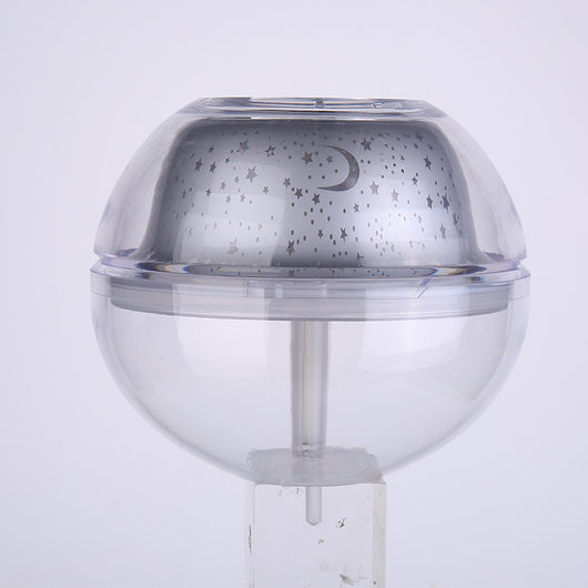 Silver and clear spherical essential oil diffuser with a starry night LED projector, featuring moon and star patterns. - Image 9