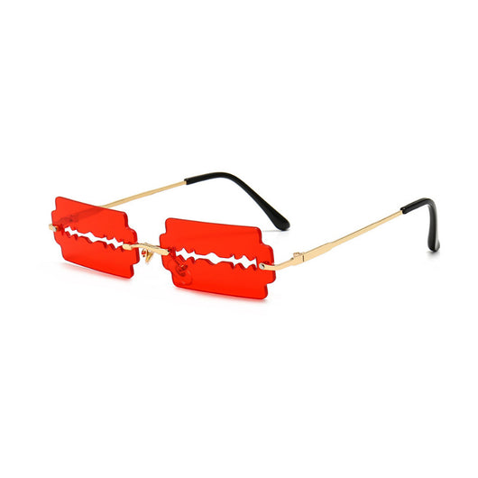 Orange razor blade shaped rimless sunglasses with gold metal frames and black ear tips on a white background. - Image 6