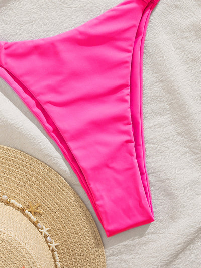 Woman wearing a royal blue two-piece bikini with a knotted front top and high-cut ruched bottom on a sandy beach. - Image 38