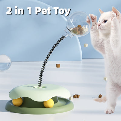 Mint green and dark green cat leakage food toy with a clear spherical treat dispenser on a black spring.