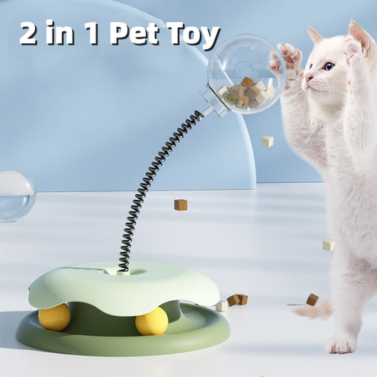 Mint green and dark green cat leakage food toy with a clear spherical treat dispenser on a black spring.