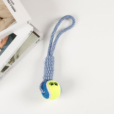 Red, pink, and white braided cotton rope dog toy with a green and red tennis ball featuring black paw prints. - Image 7