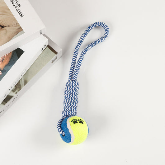 Red, pink, and white braided cotton rope dog toy with a green and red tennis ball featuring black paw prints. - Image 7