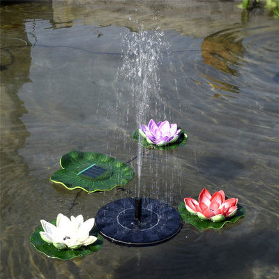 5W solar fountain kit with black solar panel on a ground stake, water pump, coiled hose, and various nozzles. - Image 13