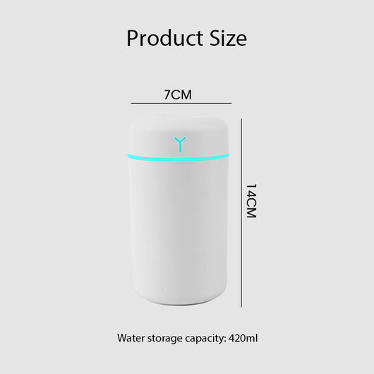 Pink portable humidifier with a blue LED light band, emitting fine mist, on a white pedestal. - Image 4
