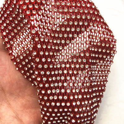 Close-up of a blue mesh fabric adorned with numerous small, clear rhinestones, creating a sparkling texture. - Image 13