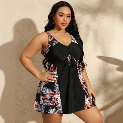 Plus size women's navy blue swimsuit with a V-neck, ruched bust, and tropical floral print skirt bottom. - Image 4