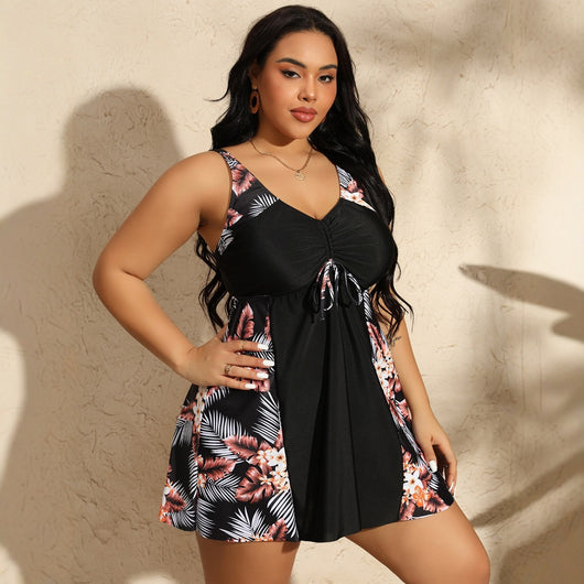 Plus size women's navy blue swimsuit with a V-neck, ruched bust, and tropical floral print skirt bottom. - Image 4