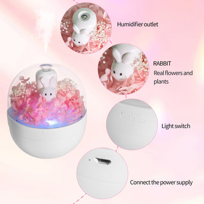 White rabbit preserved flower aromatherapy humidifier with pink flowers and blue light under a clear dome. - Image 4