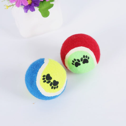 Red and green pet tennis ball with black paw print graphics, a durable rubber dog toy for fetch. - Image 5