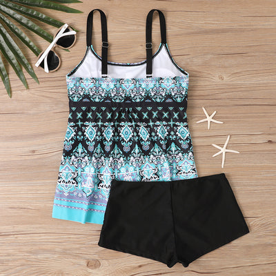 Woman in a black and white abstract print tankini top with black swim shorts on a sunny beach. - Image 22