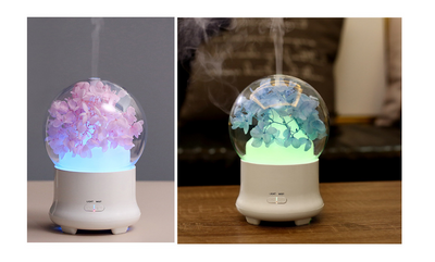 White aromatherapy machine with a clear dome top, featuring blue preserved flowers and an aqua glow. Includes 'LIGHT' and 'MIST' controls. - Image 7