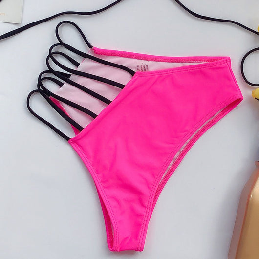 Women's neon yellow bikini with black strappy details, high-waisted bottom, and triangle top, modeled on a paddleboard at the beach. - Image 3