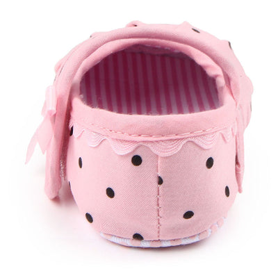 Black baby girl Mary Jane shoes with white polka dots, a strap, bow accent, and striped lining. - Image 4