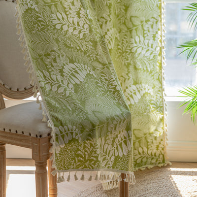 Green curtain with white leafy botanical pattern and cream tassels, hanging in a window with natural light. - Image 12