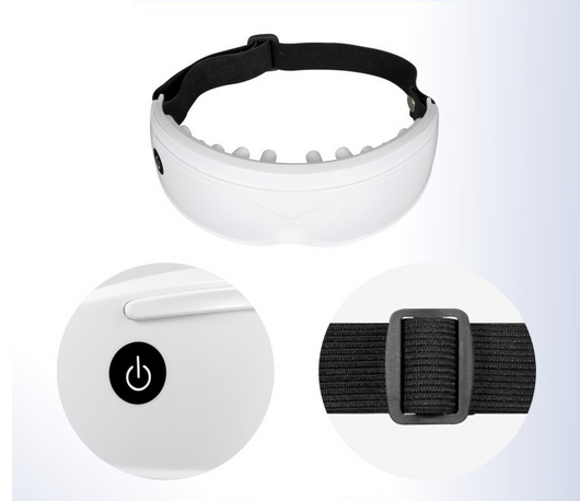 White and black eye massager with a goggle-like design, featuring a white frame and dark lenses, on a wooden surface. - Image 7