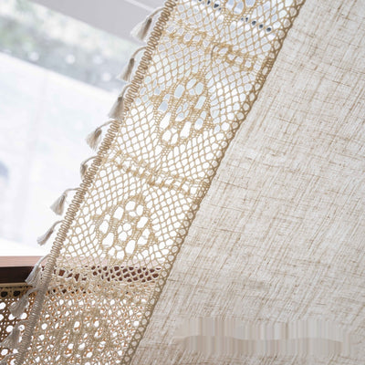 Close-up of a beige semi-transparent curtain with a delicate crochet lace trim and decorative tassels. - Image 7