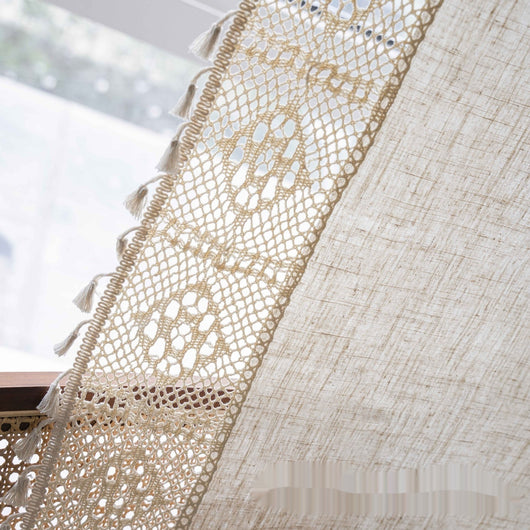 Close-up of a beige semi-transparent curtain with a delicate crochet lace trim and decorative tassels. - Image 7