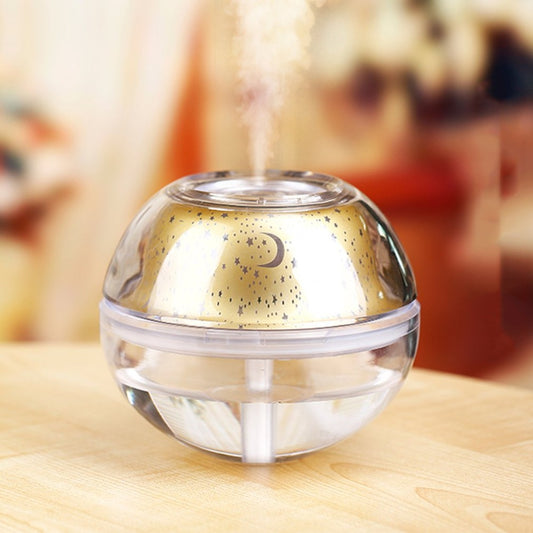Silver and clear spherical essential oil diffuser with a starry night LED projector, featuring moon and star patterns.