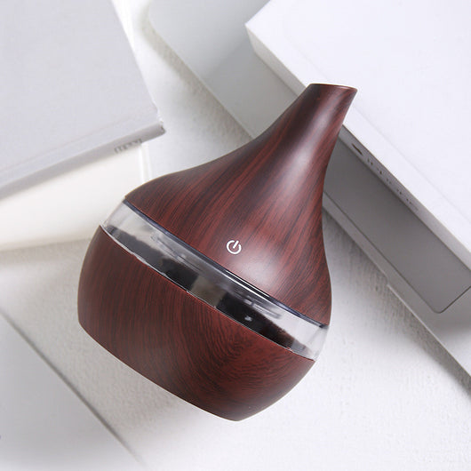 Teardrop-shaped humidifier with light wood grain finish and clear water tank, featuring a power button icon. - Image 3