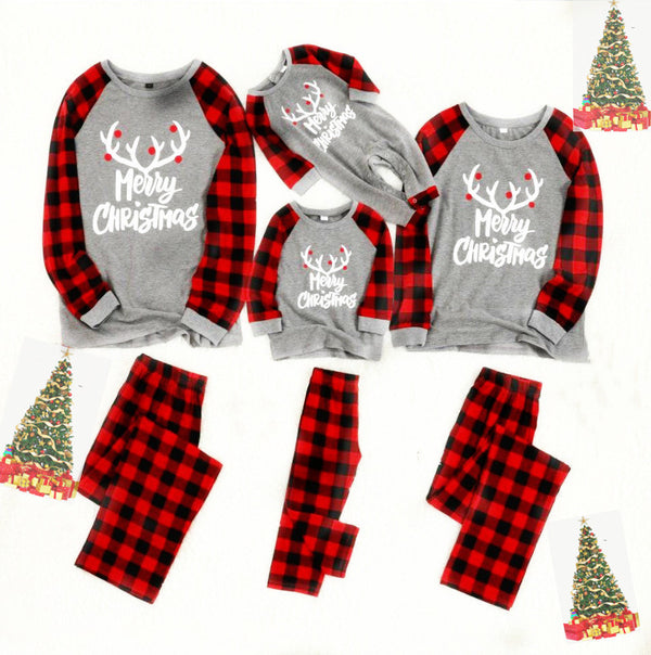 Baby's Christmas pajama set with grey 'Merry Christmas' reindeer top and red and black buffalo plaid pants.