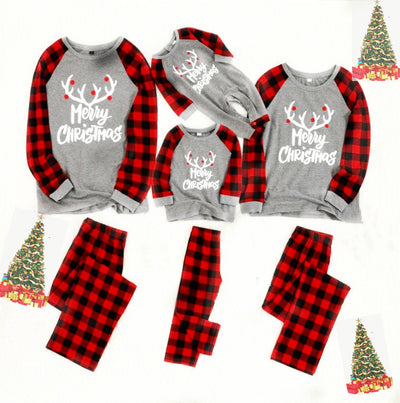 Baby's Christmas pajama set with grey 'Merry Christmas' reindeer top and red and black buffalo plaid pants.